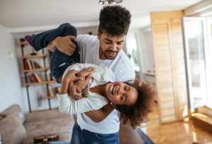 Father playing with her little daughter